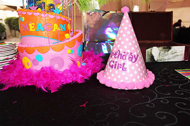 orange cake with pink party hat